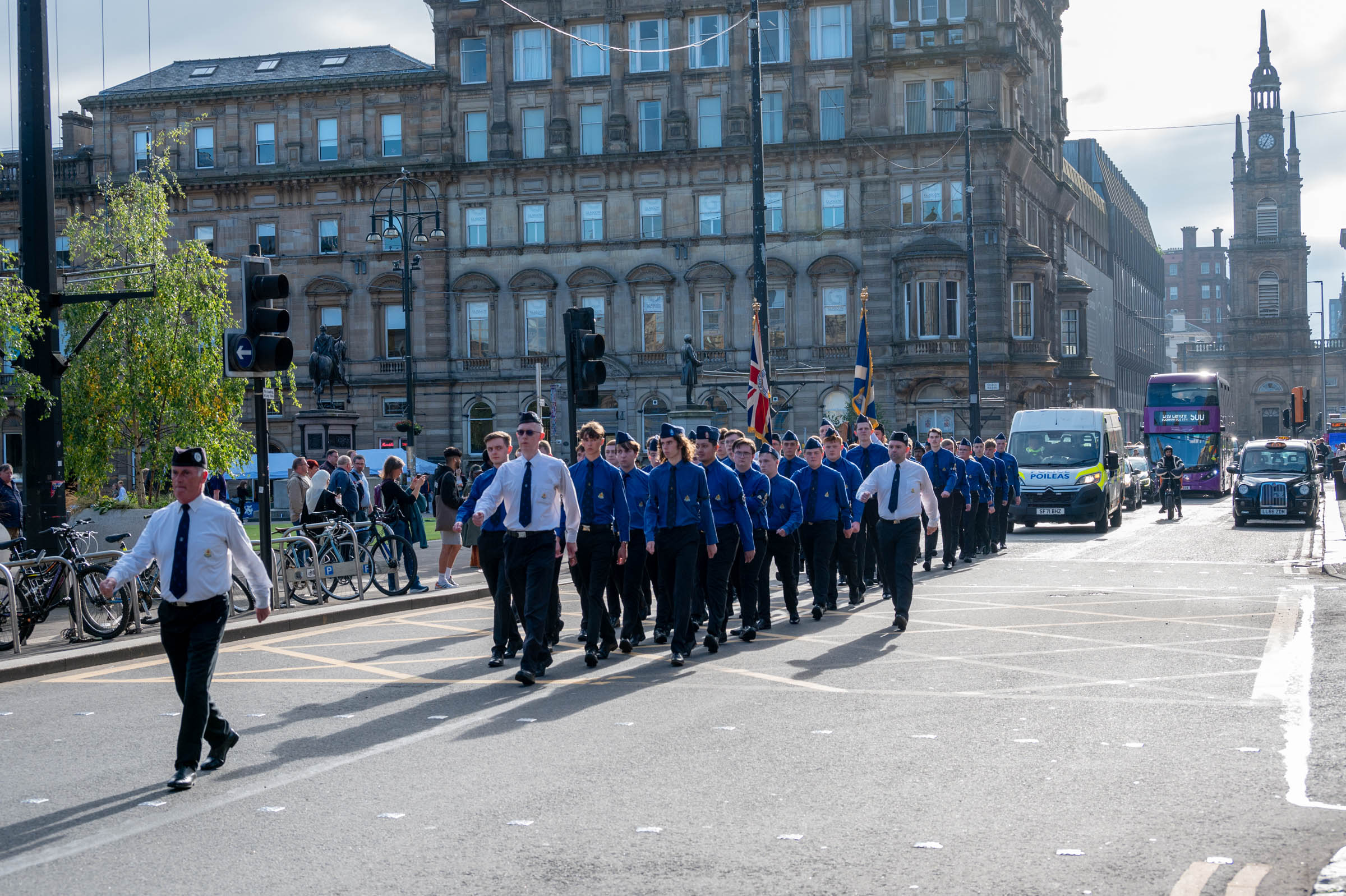 The parade of Queen's Men marching along the north side of George Square en route to Glasgow City Chambers
